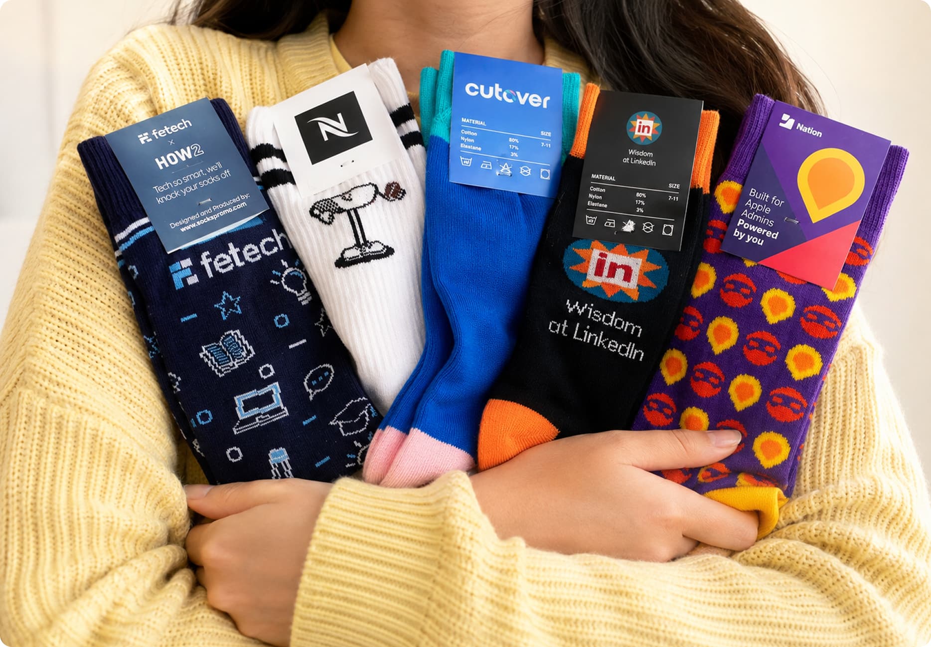 Person holding a stack of custom branded socks